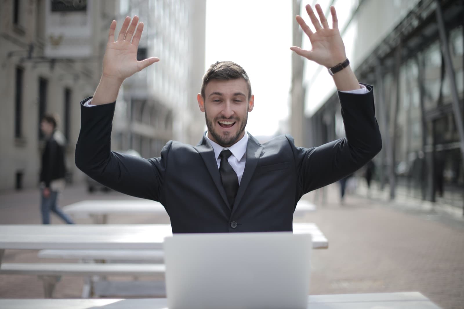 Man celebrating a win in front of his laptop